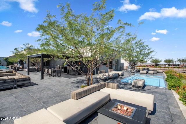 view of patio featuring a gazebo and an outdoor living space with a fire pit