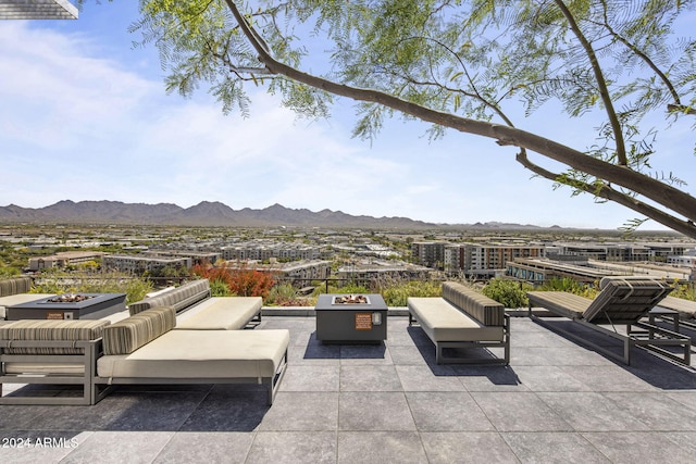 view of patio / terrace featuring a mountain view and an outdoor fire pit