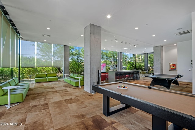 recreation room with pool table and expansive windows