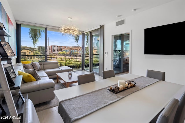 living room with a wall of windows, a healthy amount of sunlight, and a notable chandelier