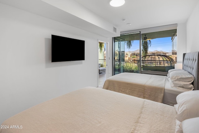 bedroom featuring multiple windows and access to exterior