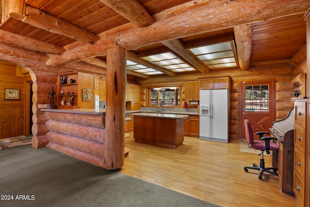 kitchen with wood ceiling, white refrigerator with ice dispenser, a center island, light hardwood / wood-style flooring, and sink