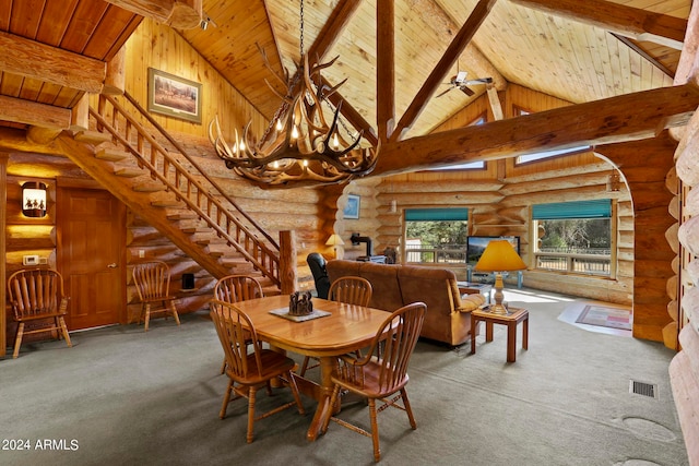 carpeted dining area with beamed ceiling, rustic walls, a chandelier, and high vaulted ceiling