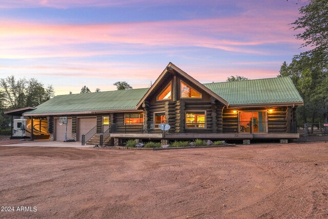 703 N Chaparral Pines Dr, Payson, AZ 85541 - log home featuring metal roof, driveway, log exterior, covered porch, and a garage