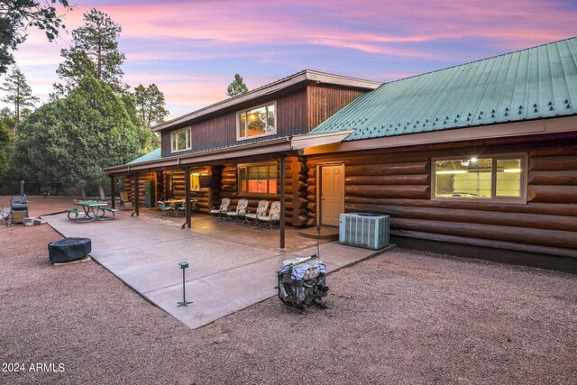 703 N Chaparral Pines Dr, Payson, AZ 85541 - back of property featuring central air condition unit, metal roof, log siding, and a patio