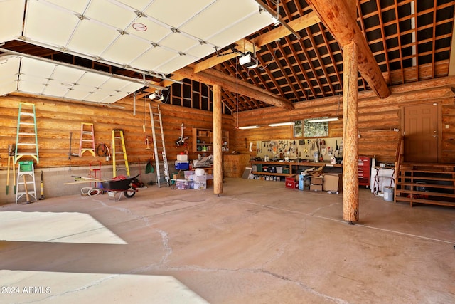 garage with a garage door opener and a workshop area