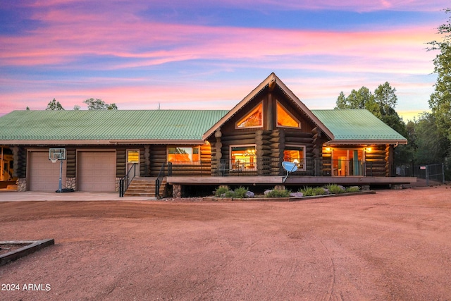 cabin featuring a porch and a garage