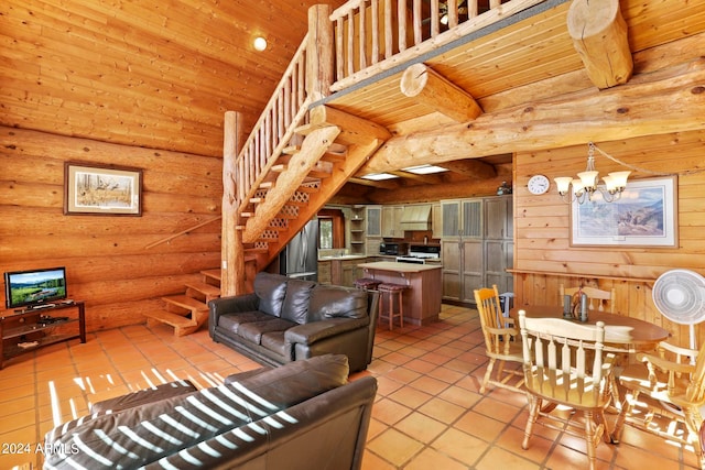 living room with wood ceiling, light tile patterned flooring, beamed ceiling, an inviting chandelier, and rustic walls