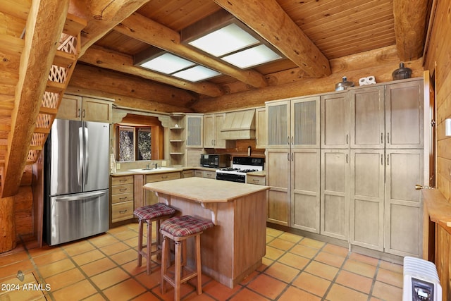 703 N Chaparral Pines Dr, Payson, AZ 85541 - kitchen with light countertops, white gas stove, premium range hood, beamed ceiling, and freestanding refrigerator