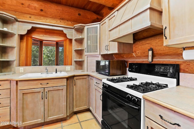 kitchen featuring light brown cabinetry, light tile patterned flooring, white range with gas stovetop, and sink