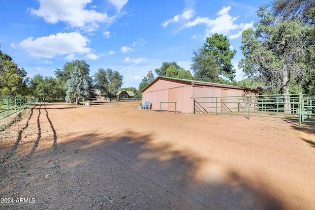 view of yard featuring a rural view and an outbuilding