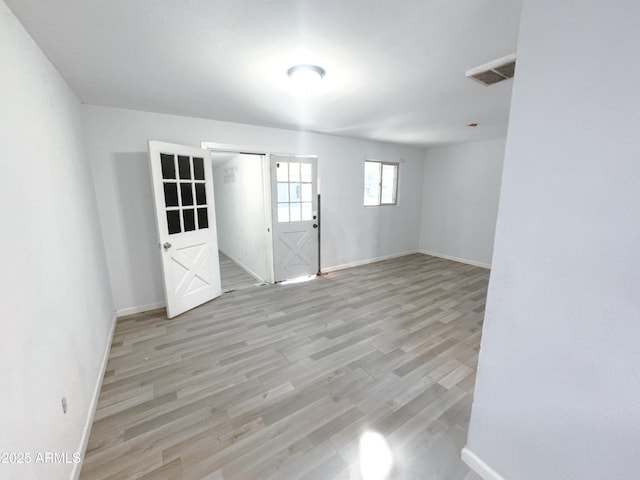 spare room with light wood-type flooring