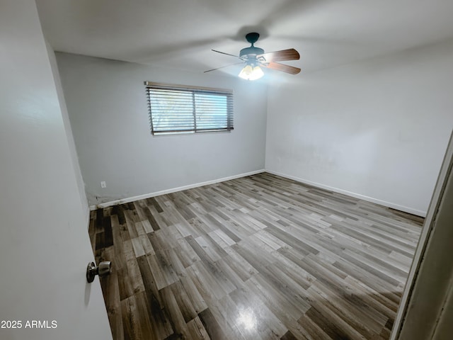 spare room featuring light wood-type flooring and ceiling fan