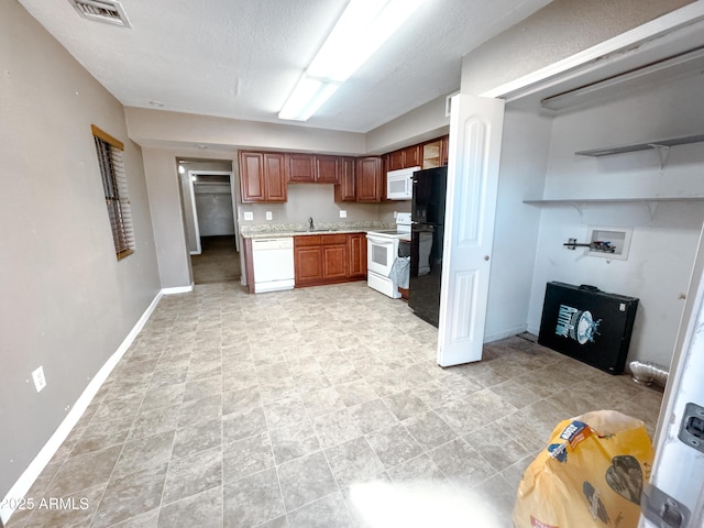 kitchen with white appliances and a textured ceiling