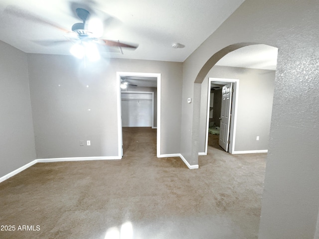 unfurnished room featuring ceiling fan and carpet flooring