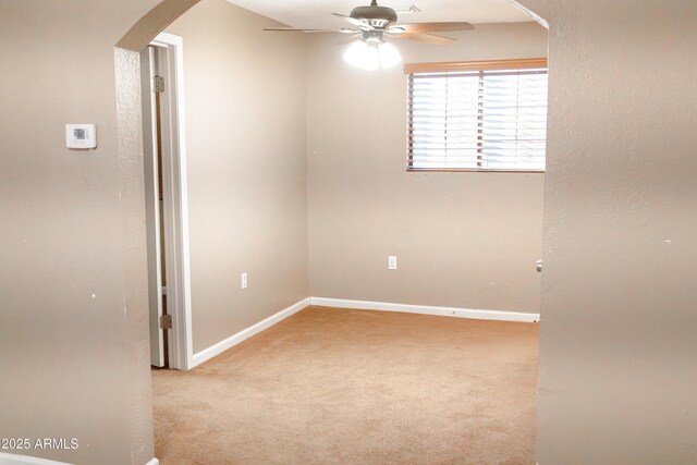 empty room featuring light carpet and ceiling fan