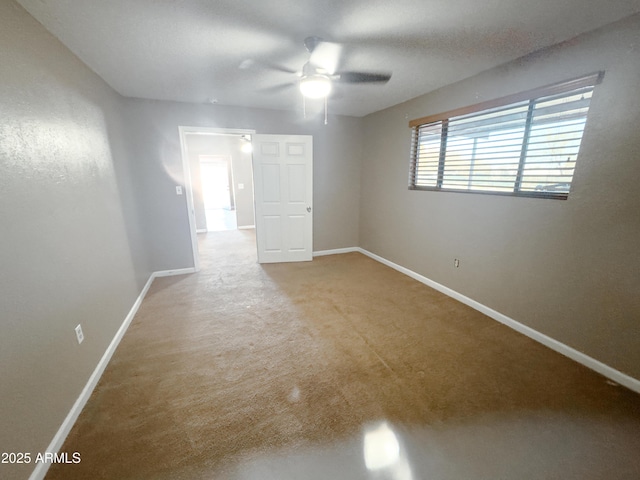 empty room featuring ceiling fan and carpet floors