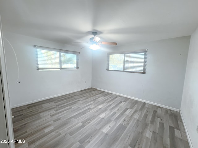 unfurnished room featuring light hardwood / wood-style floors and ceiling fan