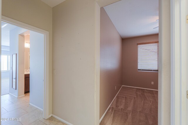 hall featuring light colored carpet