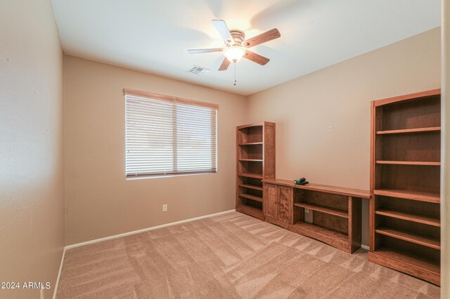 interior space featuring ceiling fan and light carpet