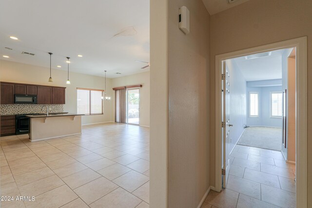 interior space featuring sink, ceiling fan, and light tile patterned floors