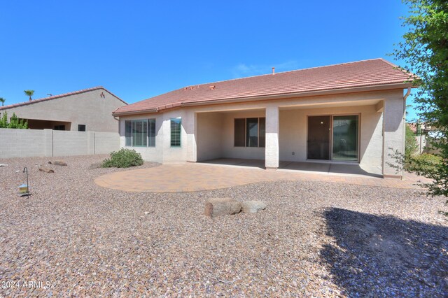 back of property with a patio