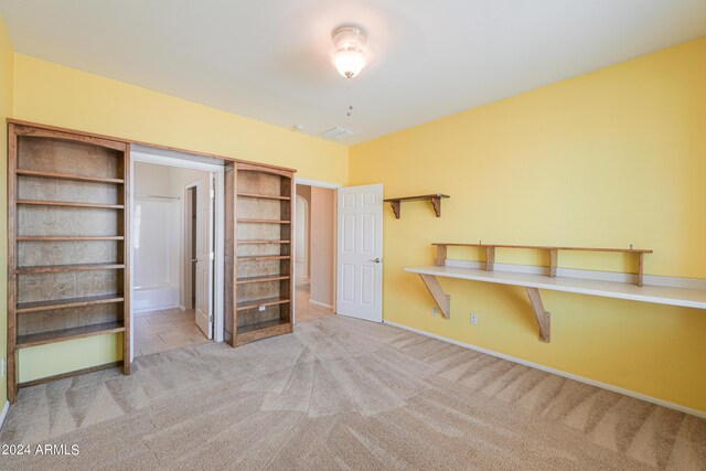 unfurnished bedroom with light colored carpet