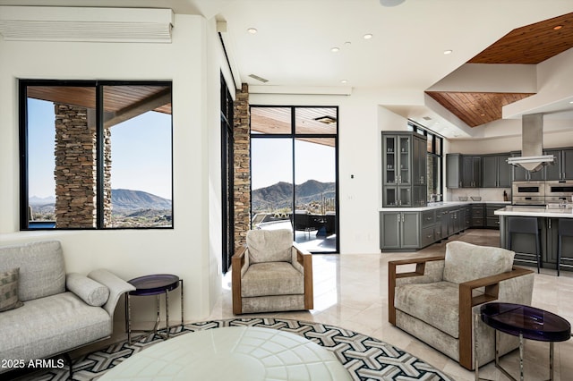 living area featuring a mountain view and recessed lighting