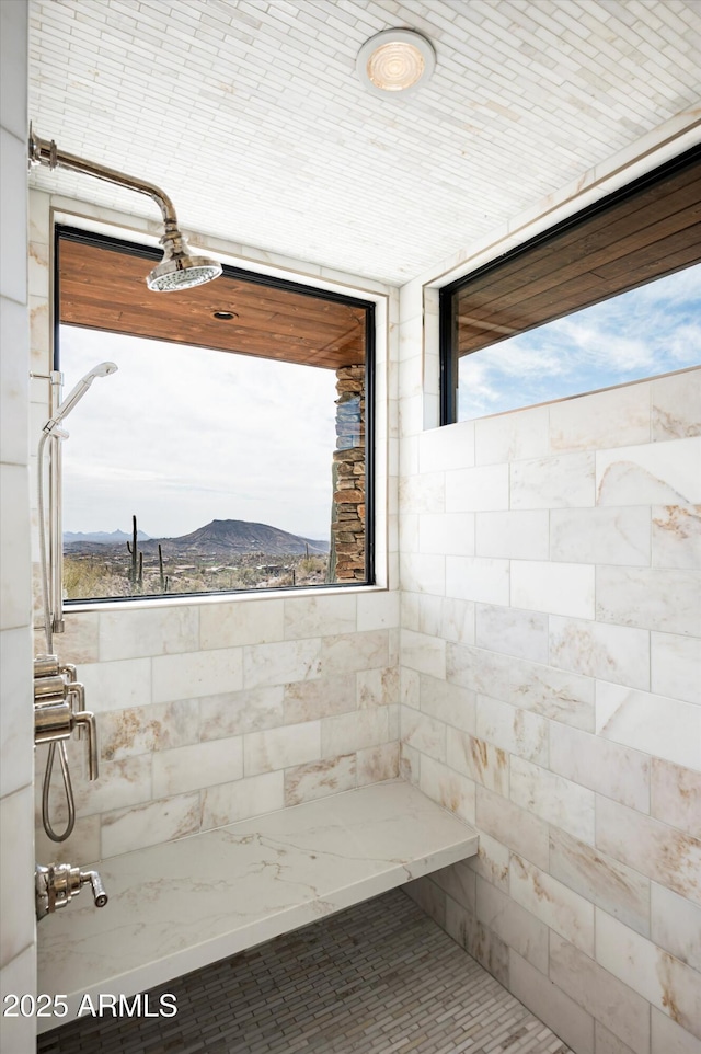 full bath featuring tiled shower