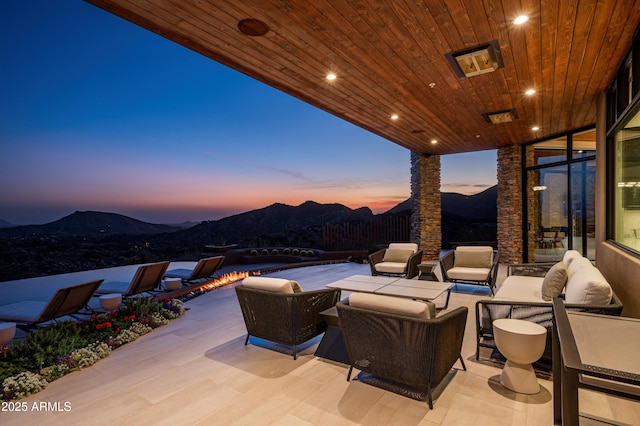 view of patio / terrace with a mountain view and an outdoor hangout area