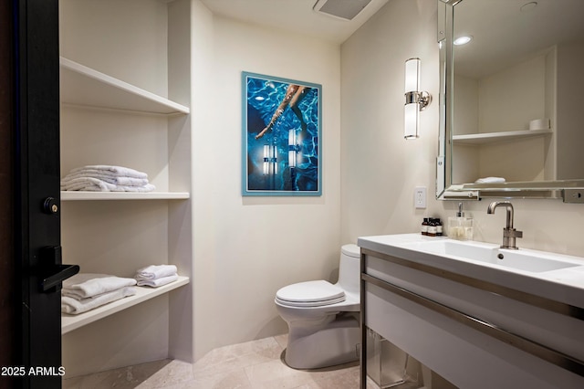 half bathroom featuring toilet, visible vents, and vanity