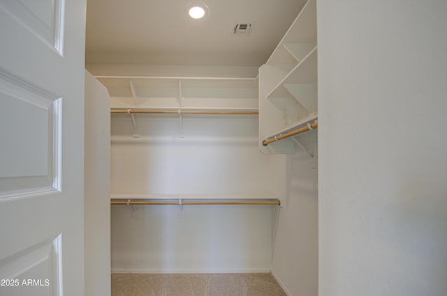 spacious closet with light carpet