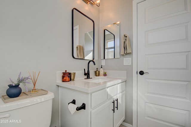 bathroom featuring toilet and vanity