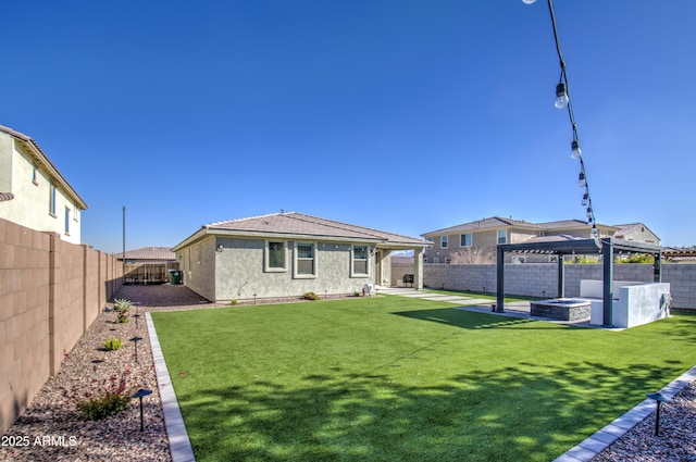 rear view of property featuring a yard, an outdoor fire pit, a patio area, and a gazebo