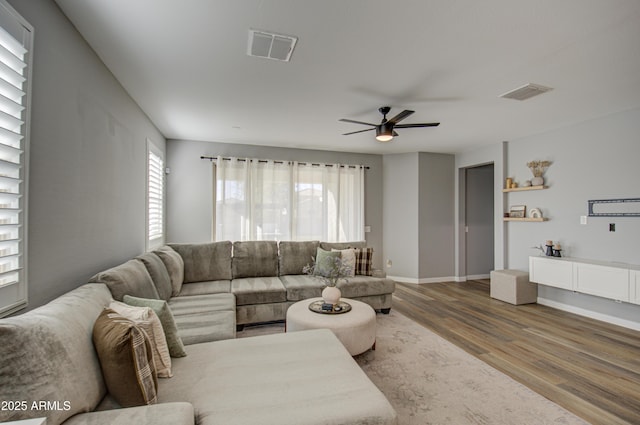 living room featuring ceiling fan and hardwood / wood-style floors