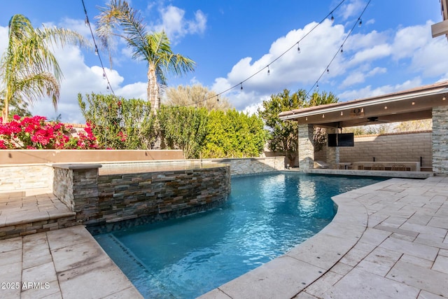 view of pool featuring pool water feature, ceiling fan, and a patio area