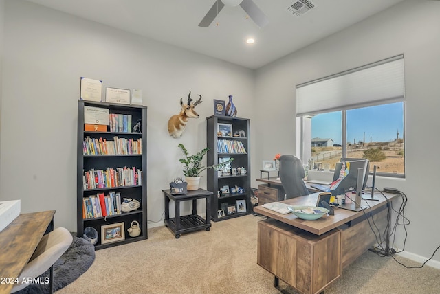 carpeted office space featuring ceiling fan