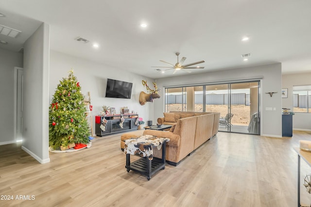 living room with ceiling fan and light hardwood / wood-style floors