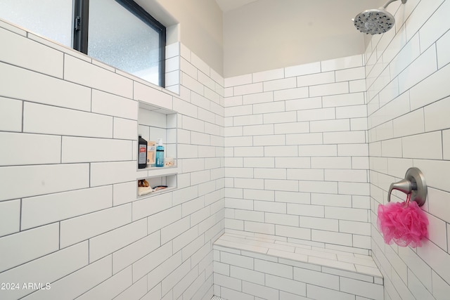 bathroom with a tile shower