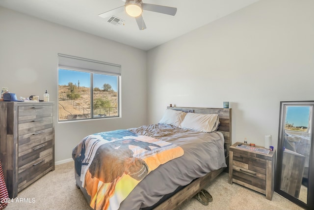 bedroom with light carpet and ceiling fan