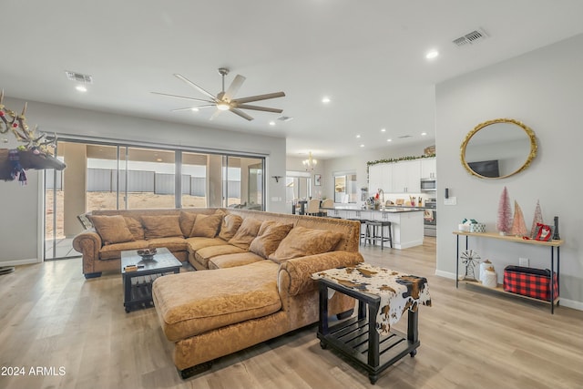 living room featuring light wood-type flooring and ceiling fan