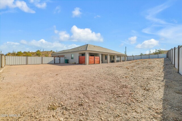 back of property featuring an outbuilding