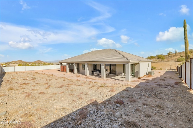 back of property with a patio area and a mountain view