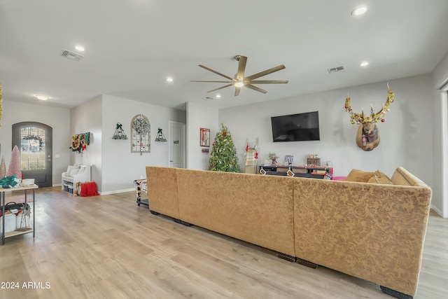 living room featuring ceiling fan and light hardwood / wood-style floors