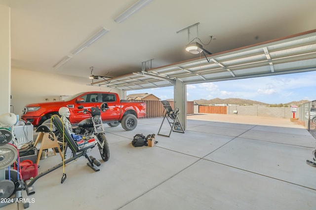 garage featuring a mountain view and a garage door opener