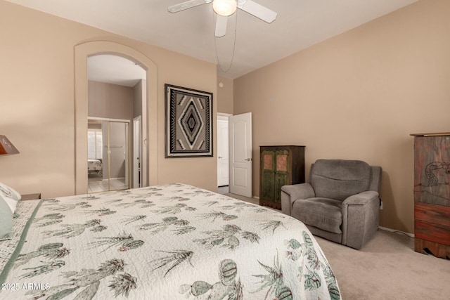 carpeted bedroom featuring connected bathroom and ceiling fan