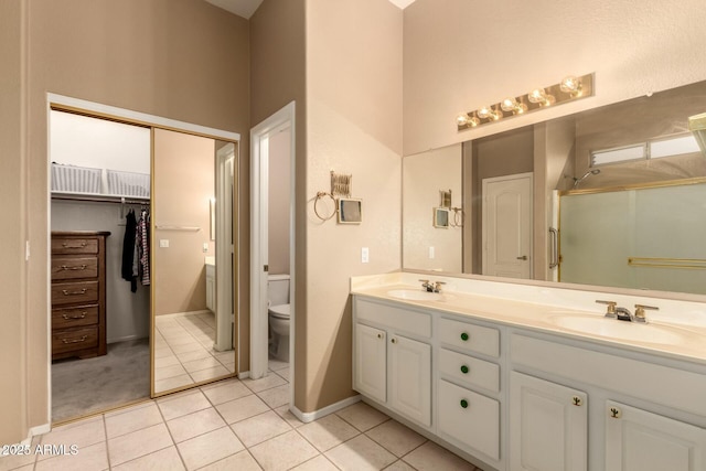 bathroom featuring vanity, toilet, and tile patterned floors