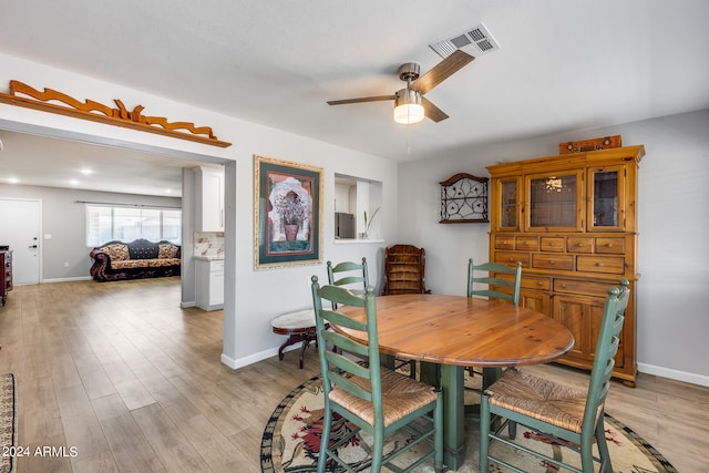 dining area with ceiling fan and light wood-type flooring