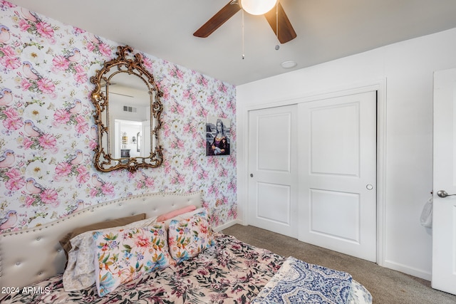 carpeted bedroom featuring a closet and ceiling fan