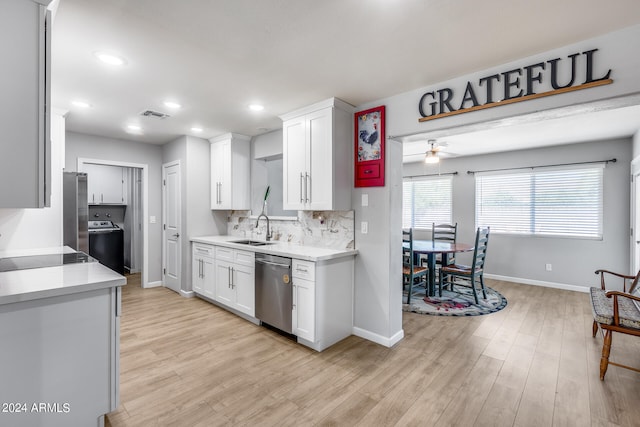 kitchen with light wood-type flooring, white cabinetry, stainless steel appliances, and ceiling fan